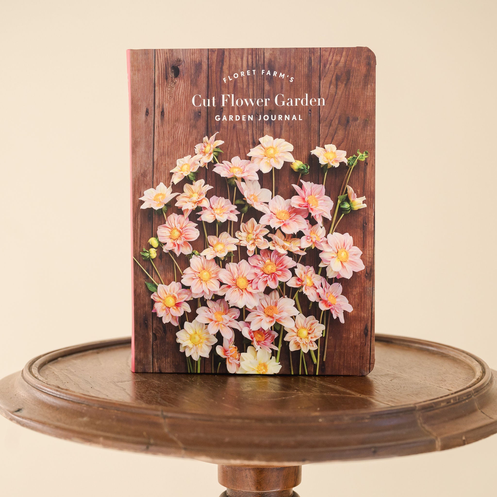 close up cover photo of Cut Flower Garden, Garden Journal sitting on a wooden stool 