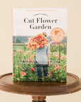 Cover of Cut Flower Garden book sitting on a round wooden stool 